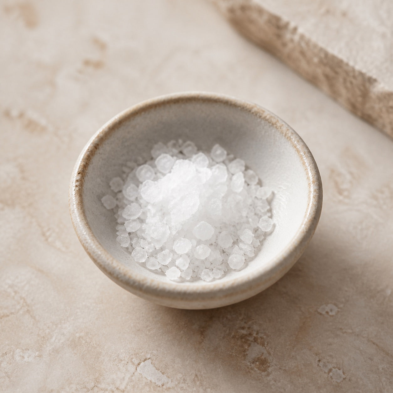 Natural salt crystals in a small ceramic bowl